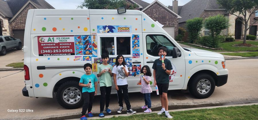 Kids and families at the A1 Ice Cream truck window at a community event